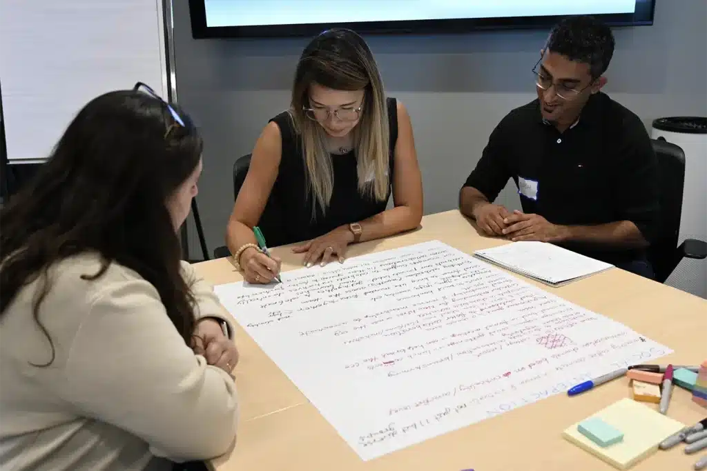 Three people working together on their business during a meeting