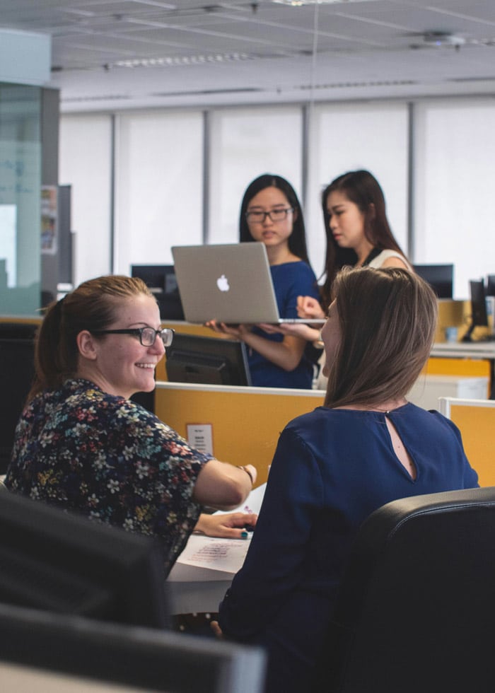 Female coworkers talking at work