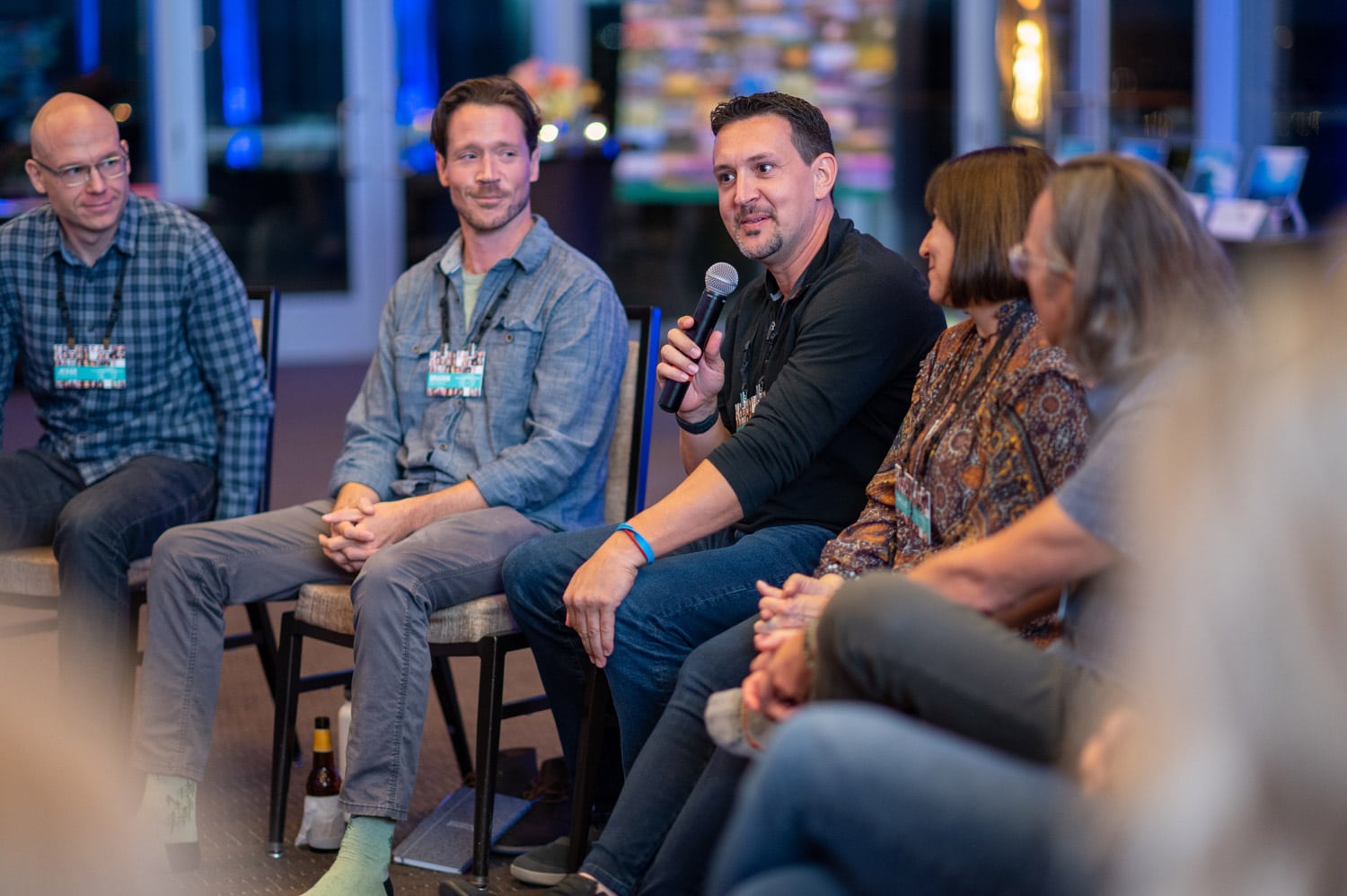 Michael speaks with a group at a conference